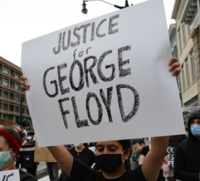 Protester holding sign saying Justice for George Floyd