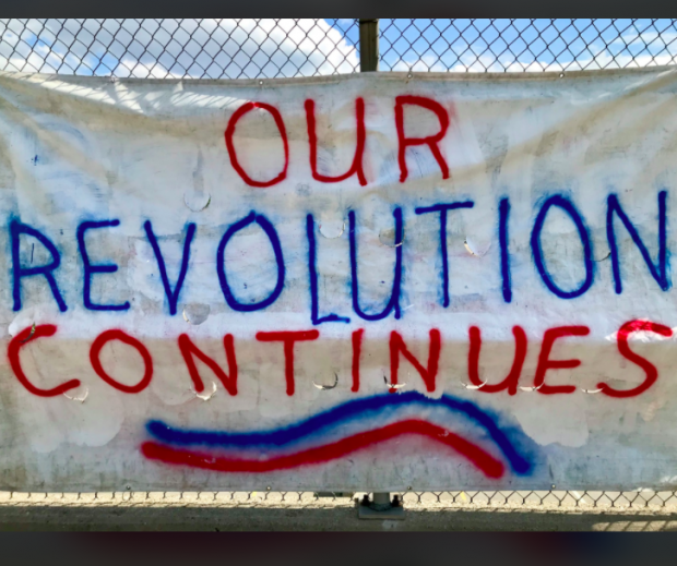 Sign saying Our Revolution Continues