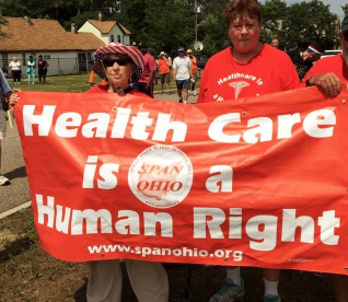 People holding banner that says Health Care is a Human Right