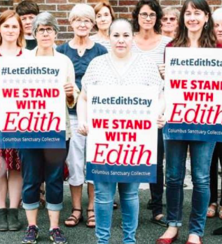 People holding signs that say Solidarity with Edith