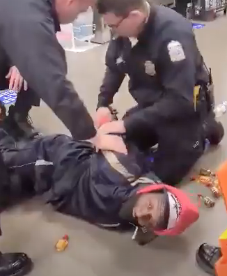 Cops holding a black man down