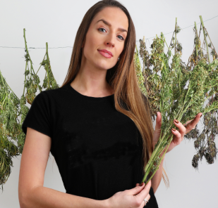 Woman holding marijuana plant