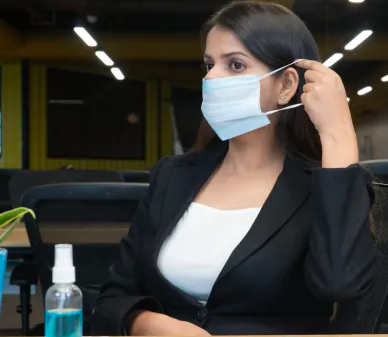 Woman wearing mask in office