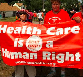 People holding banner saying Health Care is a Human Right