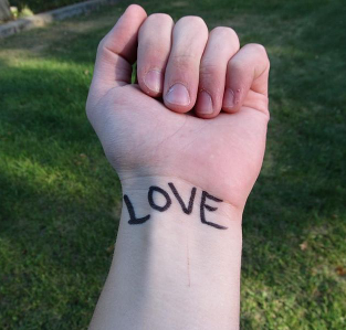 Love tattooed on a wrist