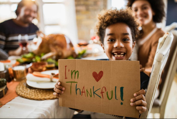 Little boy holding sign I'm Thankful