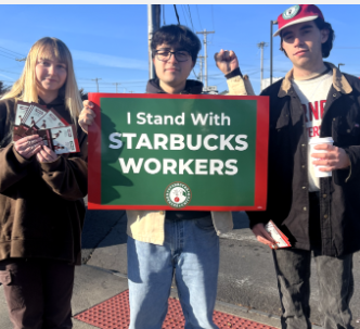 Three young people standing with sign saying I stand with Starbucks workers