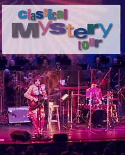 Band on stage under sign saying Classical Mystery Tour