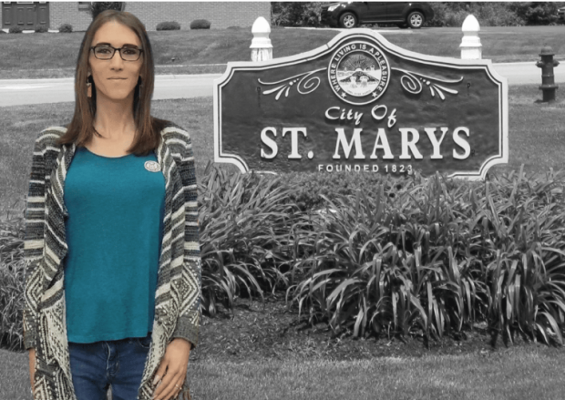 Woman standing next to St. Mary's sign