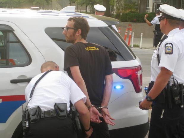 Activist being handcuffed by police