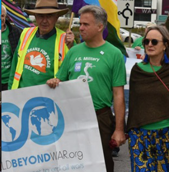 David Swanson marching with World Beyond War banner