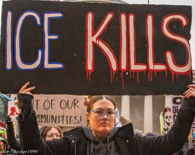 Woman with ICE Kills sign