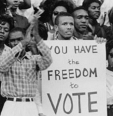 People from 60s with sign saying You Have the Freedom to Vote