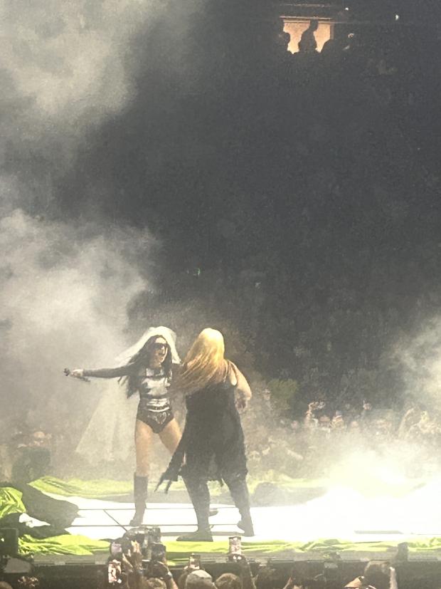 Women on stage at a concert with lots of smoke