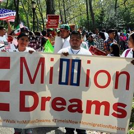 Latino young people marching and holding sign that says Million Dreams