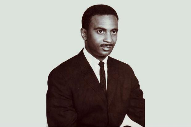 Black and white photo of young black man in a suit