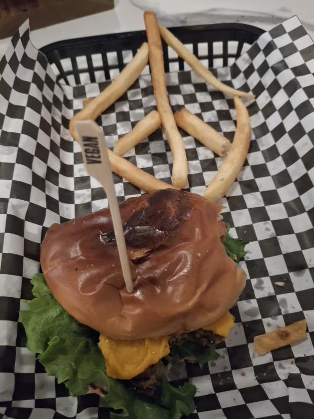 Black bean burger and fries in the shape of a peace sign