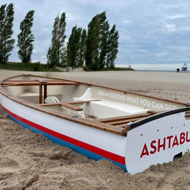 Boat on sandy beach with Ashtabula Ohio on it