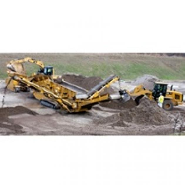 Big yellow construction machine digging into the soil