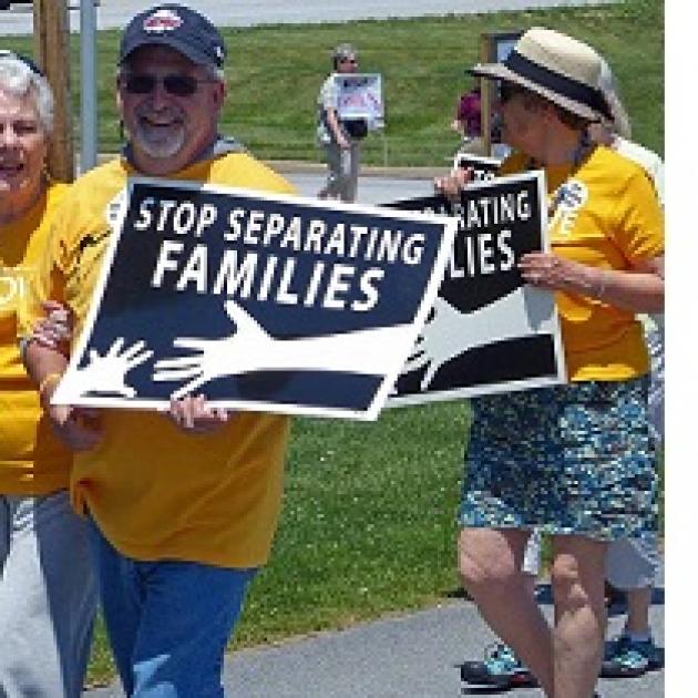 Older white people in yellow shirts holding signs that say Stop Separating Families