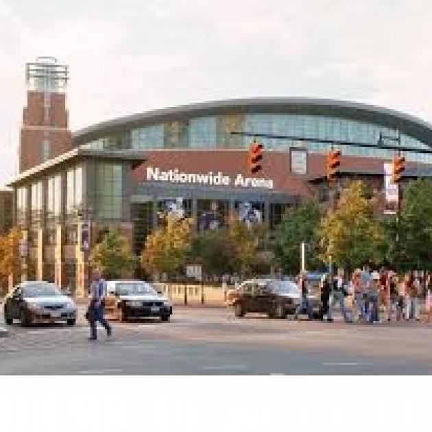 Big brick building with rounded top and lots of people out front and words on it Nationwide Arena