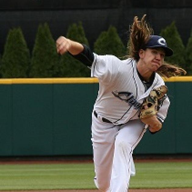 Pitcher throwing a pitch with long hair flying