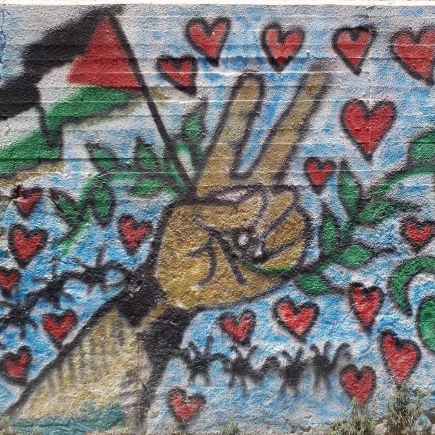 Peace sign and Palestinian flag surrounded by hearts