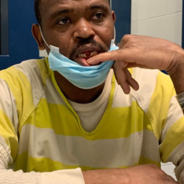 Man showing a spot in mouth where there is a gap.
