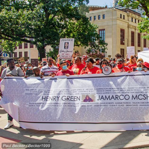 People marching with big banner