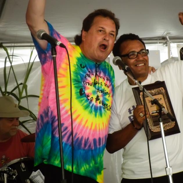 Two men on stage holding their fists in the air