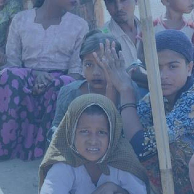 Photo of many women wearing headscarfs and looking very worried