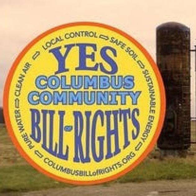 Round yellow logo with words Yes Columbus Community Bill of Rights and a fracking well in background