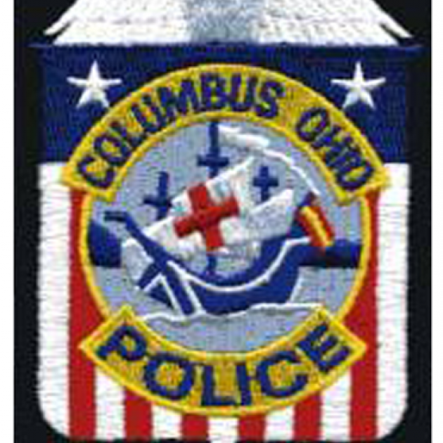 Badge with Santa Maria in center and red/white/blue background saying Columbus Ohio Police