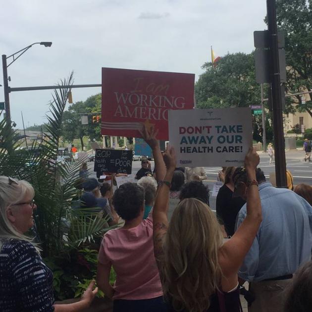 People holding signs about health care