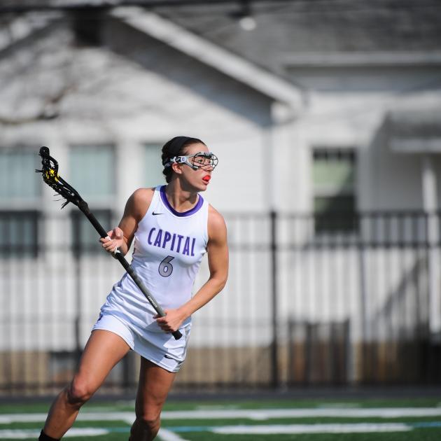 Kara Hines swinging a lacrosse stick