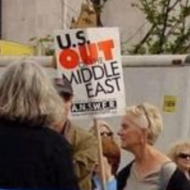 Woman holding a sign saying US Out of the Middle East