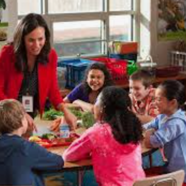 Young student with teacher in classroom