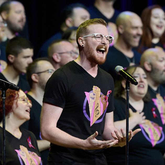 Man singing in front of chorus