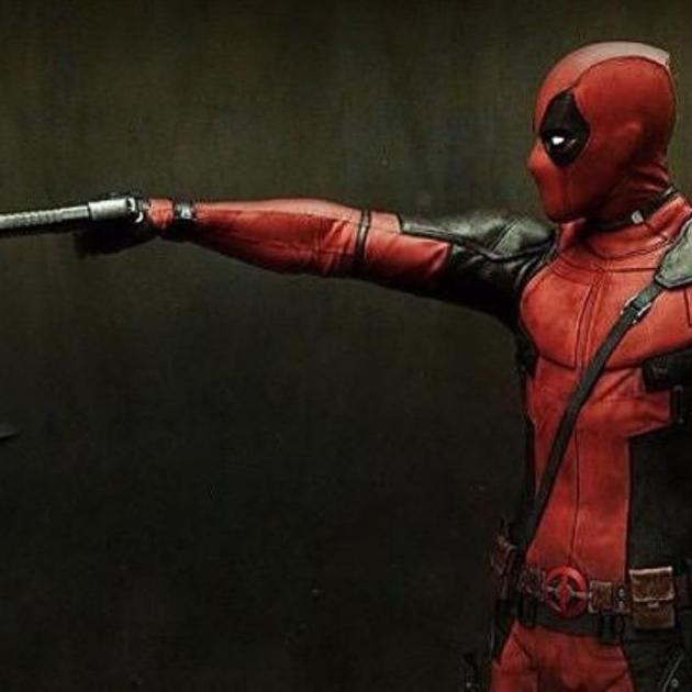 Deadpool character pointing a gun at a teddy bear