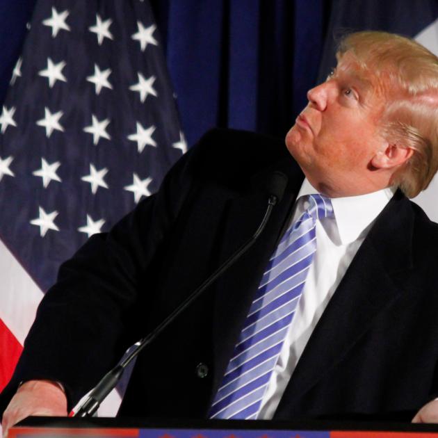 Donald Trump at podium looking sideways and stupid