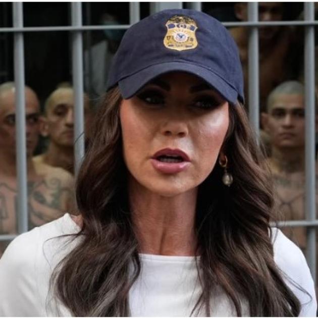 Woman in baseball cap in front of El Salvador prison