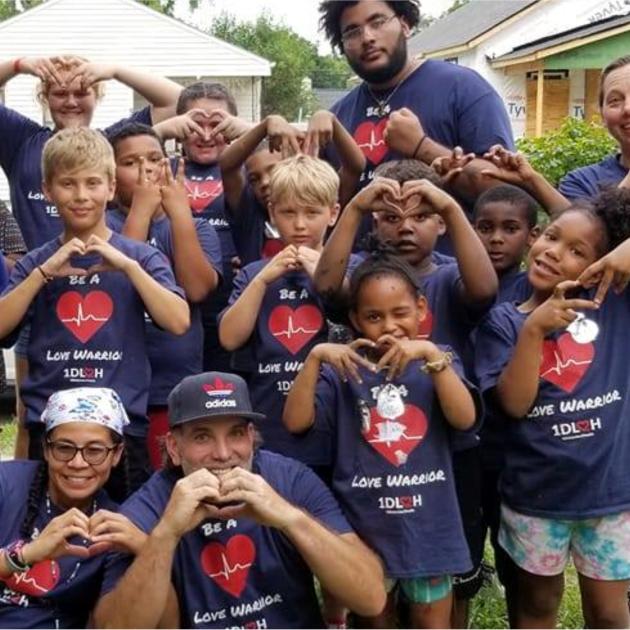 Kids making heart signs with their hands