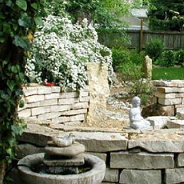 White stone fountain and pretty landscaping