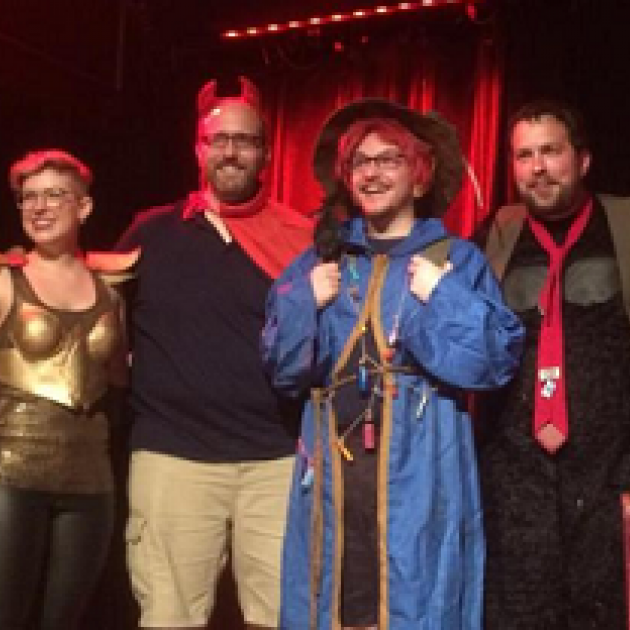 Four people dressed in geeky costumes