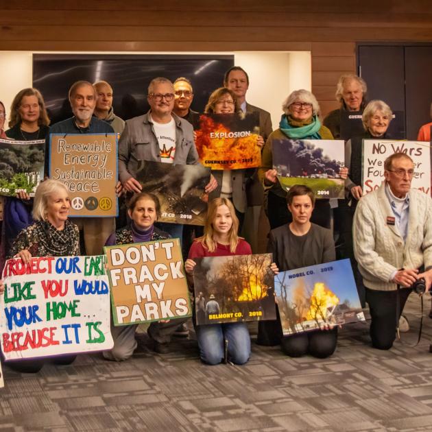 People posing with signs
