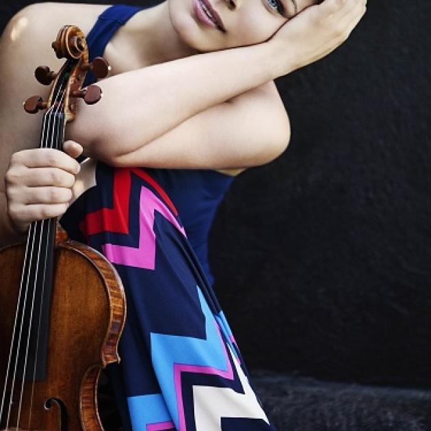 Young woman posing with a violin