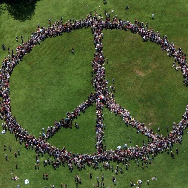 People standing as a peace sign from a distance