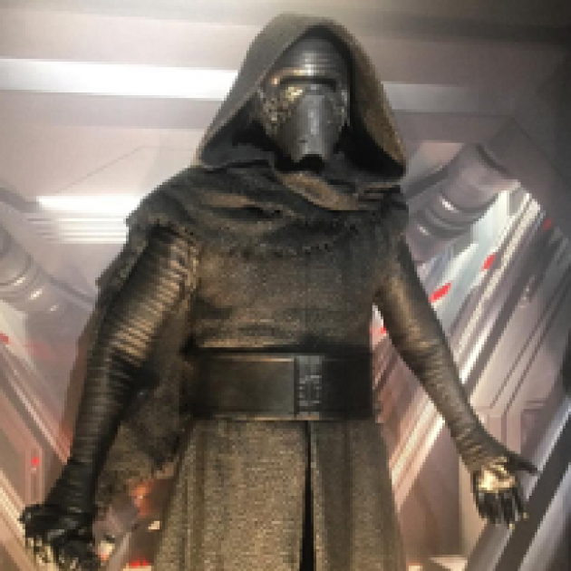 Guy in gold spacesuit looking outfit with helmet and facemask and hood from Star Wars