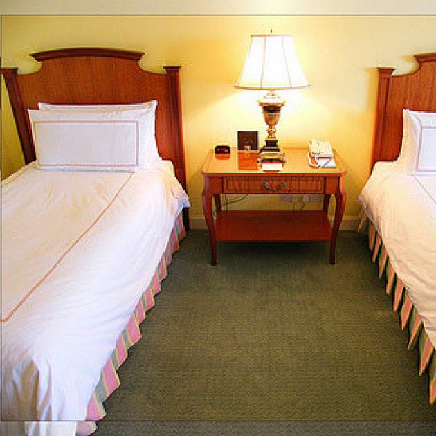 Two single beds separated in a bedroom