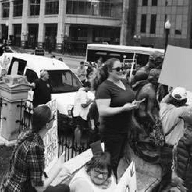 Black and white photo of people holding signs and protesting